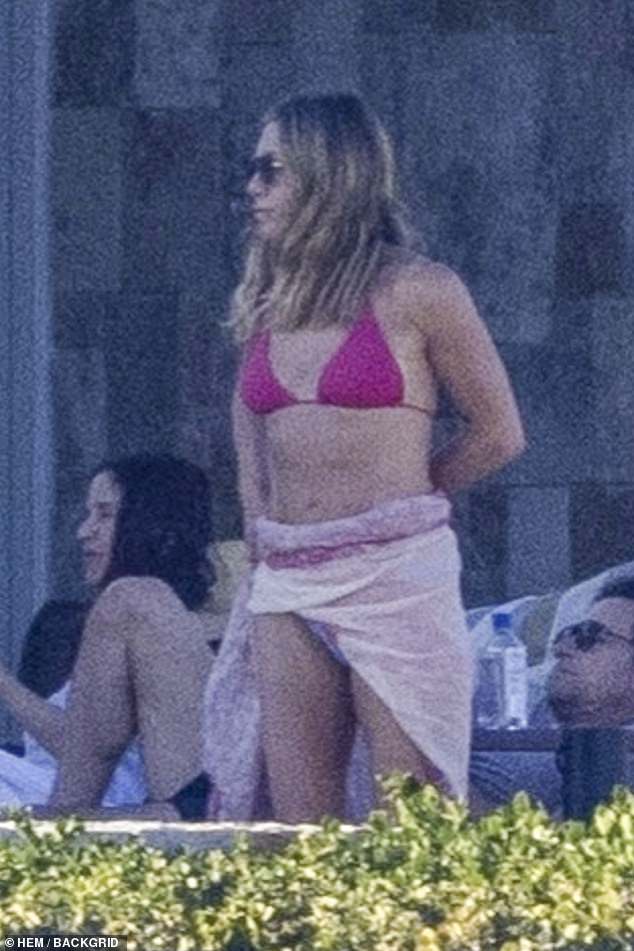 The star was wearing the same swimsuit she wore 13 years earlier, while on vacation in the same resort town with her then-fiancé Justin Theroux.