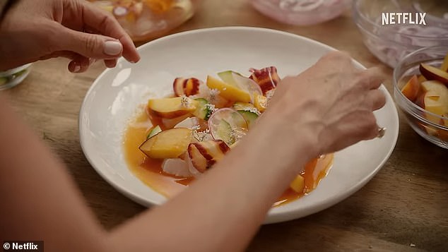 Meghan prepares a light, summery dish that appears to incorporate peaches, thinly sliced ​​radishes, and cucumber with dressing.