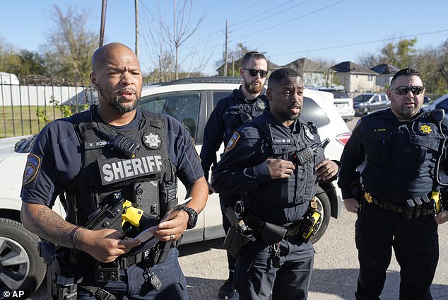 Harris County sheriff's deputies clear media from the neighborhood where suspect Shamsud-Din Bahar Jabbar, 42, is believed to have lived.