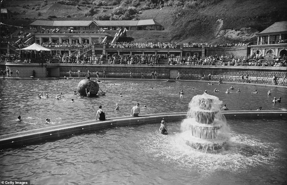 Tourists enjoy the outdoor swimming pool in Scarborough's Battery Park in 1930. The Yorkshire Post explains: 'The Art Deco attraction was the first swimming pool of its kind in England with built-in diving boards, a water slide, changing rooms and showers. It contained nearly two million gallons of filtered and chlorinated seawater. The pool was closed in 1989.