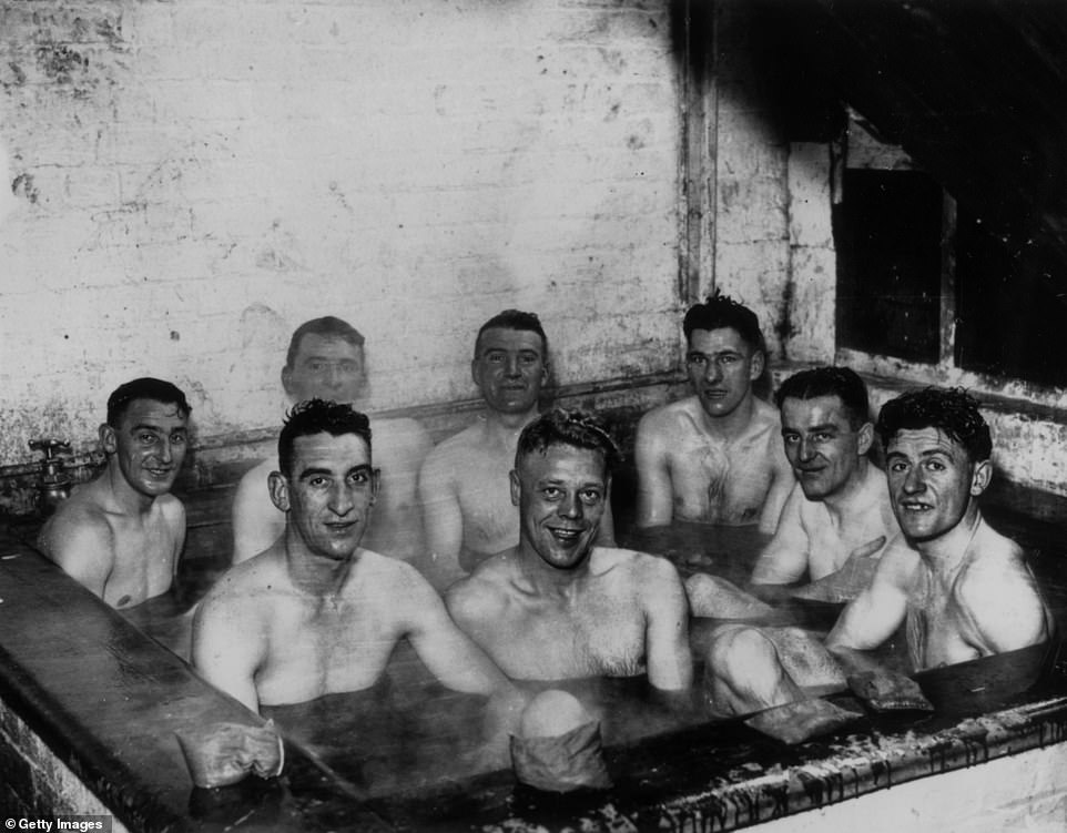 In this image from 1937, Scarborough footballers are photographed taking a seaweed bath during preparations for the FA Cup match.