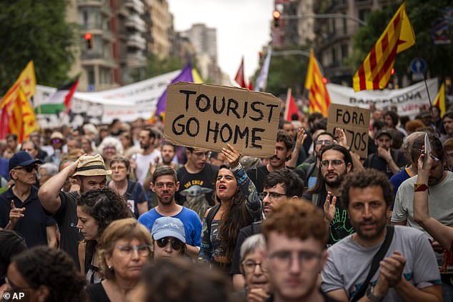 Protesters march shouting slogans against the Formula 1 Barcelona Fan Festival in central Barcelona, ​​Spain, on Wednesday, June 19, 2024.