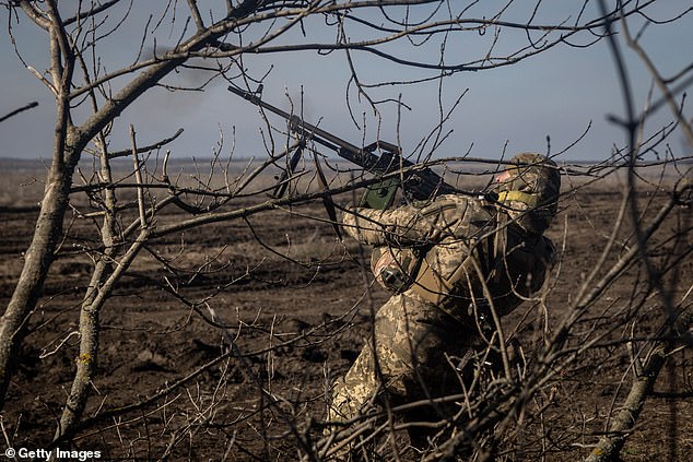 A member of the Ukrainian 72nd Brigade anti-aircraft unit fires at a Russian Zala reconnaissance drone overhead on February 23, 2024 near Marinka, Ukraine.