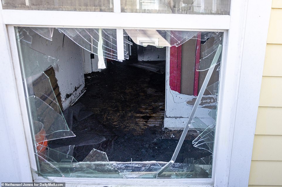 A smashed window offered a glimpse into a room that appeared to be on fire