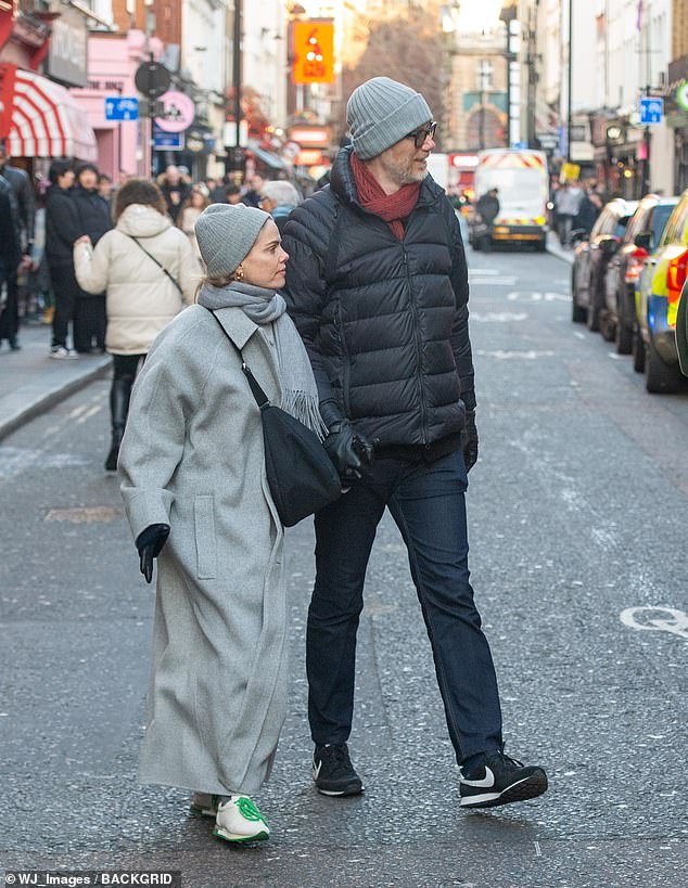 The Office writer kept comfortable in a pair of black Nike sneakers, while Mircea looked stylish in a long gray wool coat which she paired with a winter hat, scarf and gloves.