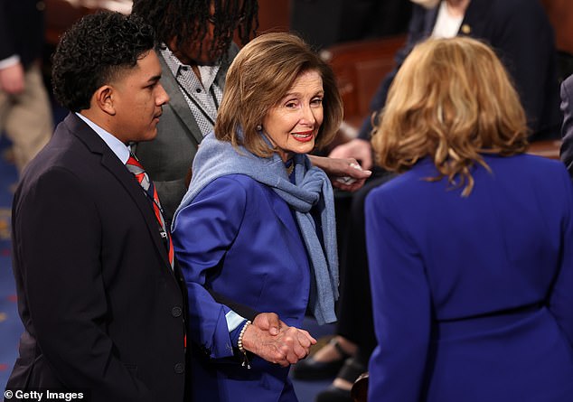 Pelosi was all smiles on Friday but was accompanied by aides as she arrived in the House chamber