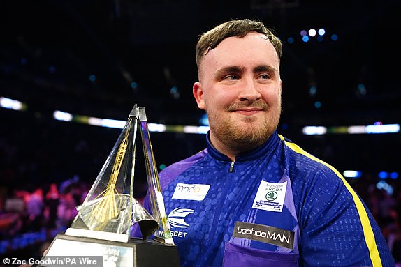 Luke Littler celebrates with the trophy after winning the final against Luke Humphries during the 2024 BetMGM Premier League play-off at the O2, London. Photo date: Thursday May 23, 2024. PA Photo. See PA story DARTS Premier League. Photo credit should read: Zac Goodwin/PA Wire.RESTRICTIONS: Use subject to restrictions. Editorial use only, no commercial use without prior consent of the rights holder.