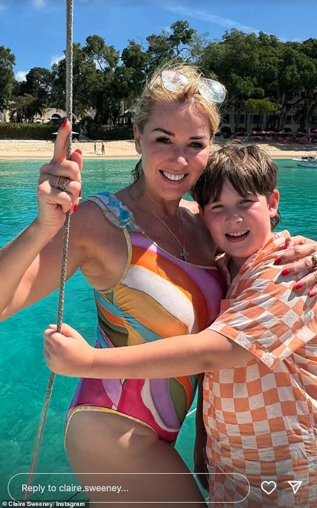 Her son smiled at the camera as he hugged Claire before enjoying a dip in the ocean.