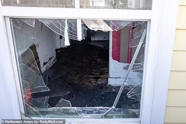 A broken window offered a glimpse inside a room that appeared to have been set on fire.