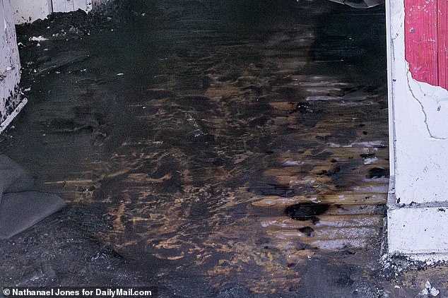 The wooden floors looked charred and covered in soot and ash.