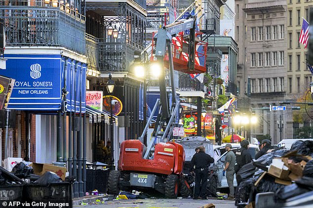 Police investigators surround a white truck that crashed into a work elevator in New Orleans' French Quarter.