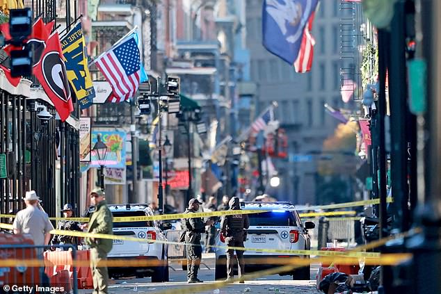 Law enforcement officers from multiple agencies work the scene on Bourbon Street.