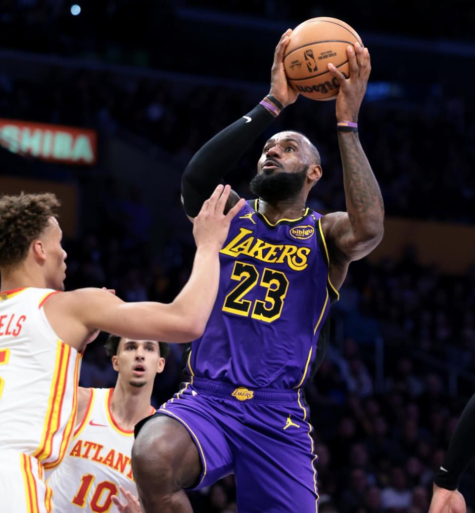 Lakers star LeBron James drives to the basket against Atlanta's Dyson Daniels in the first half on Friday.