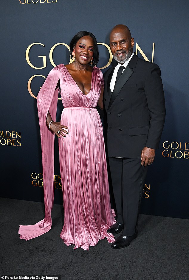 Viola was also joined on the carpet by her husband Julius Tennon, 71, who looked incredibly dapper in a black double-breasted jacket with satin lapels and tailored trousers.