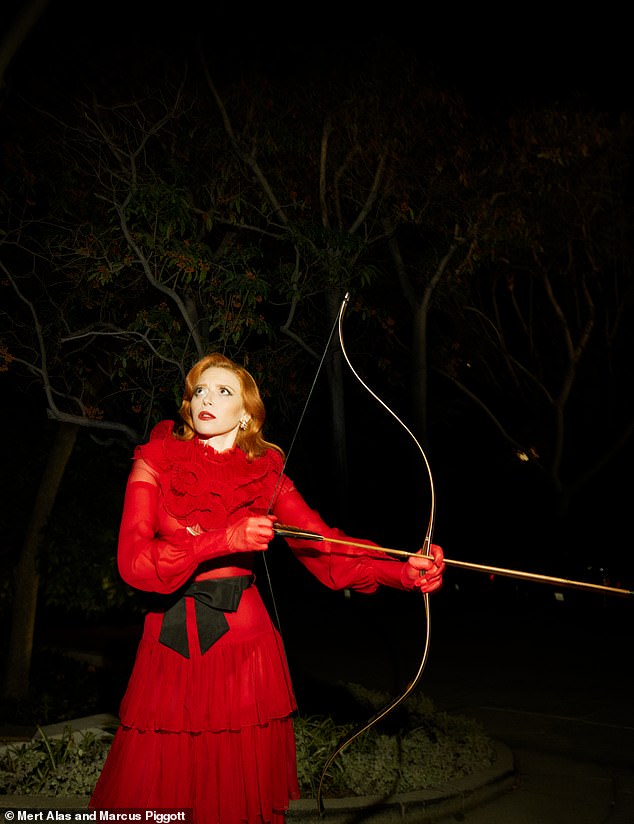 Natasha Lyonne wore a ruffled red dress as she posed with a bow and arrow.