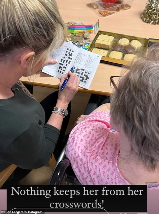 In another snap, the Loose Women star was seen with her blonde tresses pulled back into a sleek ponytail and wearing a khaki top while doing a crossword with Joan.