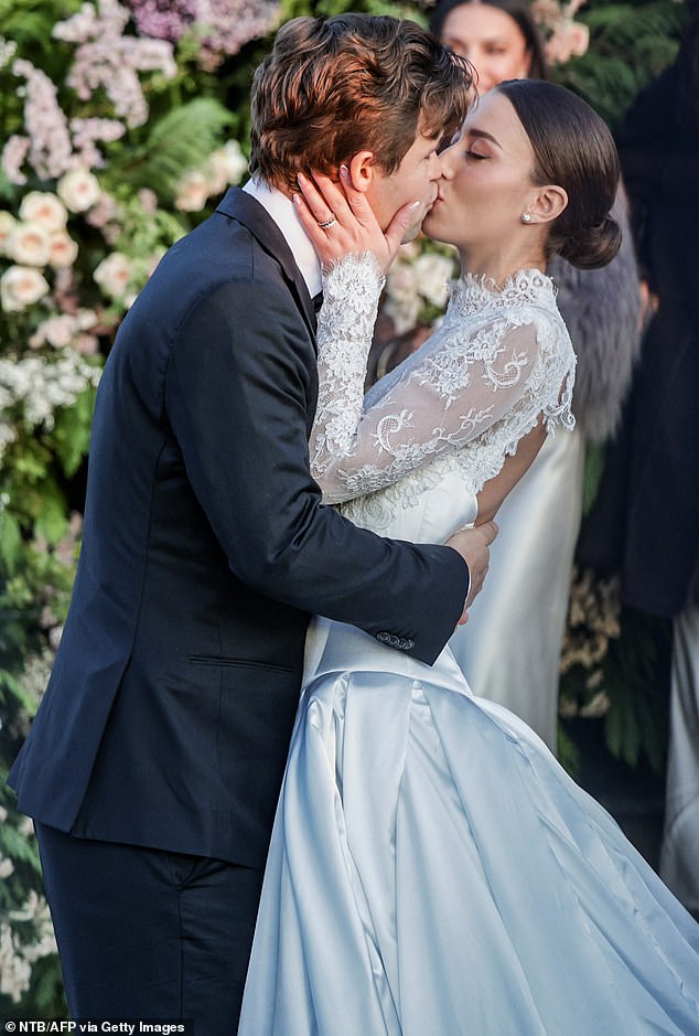 SEALED WITH A KISS: The newlyweds were not shy and showed their affection with a passionate kiss outside the chapel.