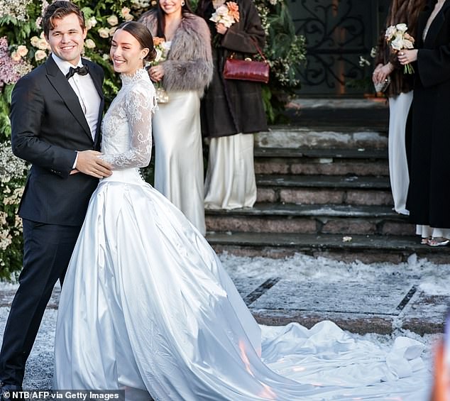 The world's number one chess player and his new girlfriend (both in the photo) posed radiantly for photographs.