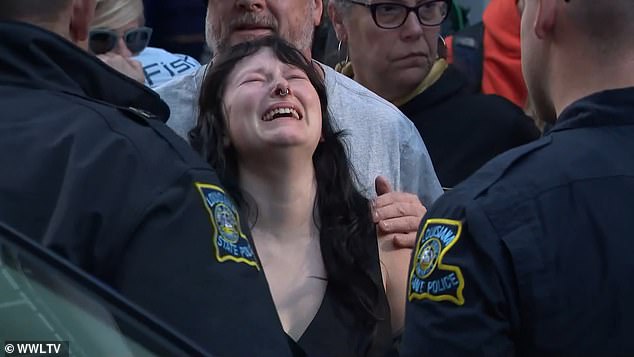 Brooke collapsed with emotion as they walked, bringing tears even to the officers escorting them, and spoke at a memorial service that formed at the scene.