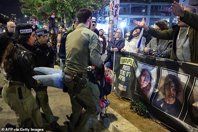 Protesters plead with police who are detaining a seemingly peaceful protester.