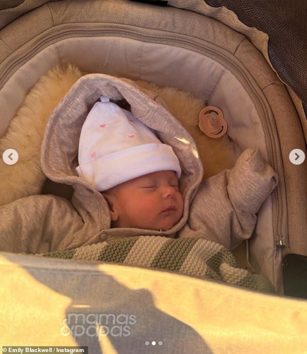 Baby Eva June fell asleep in her stroller while wrapped in her coat and adorable hat.