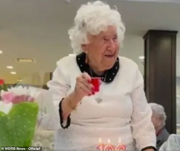 Florence 'Fireball Flo' Hackman holds up a shot of Fireball whiskey to celebrate 106th birthday