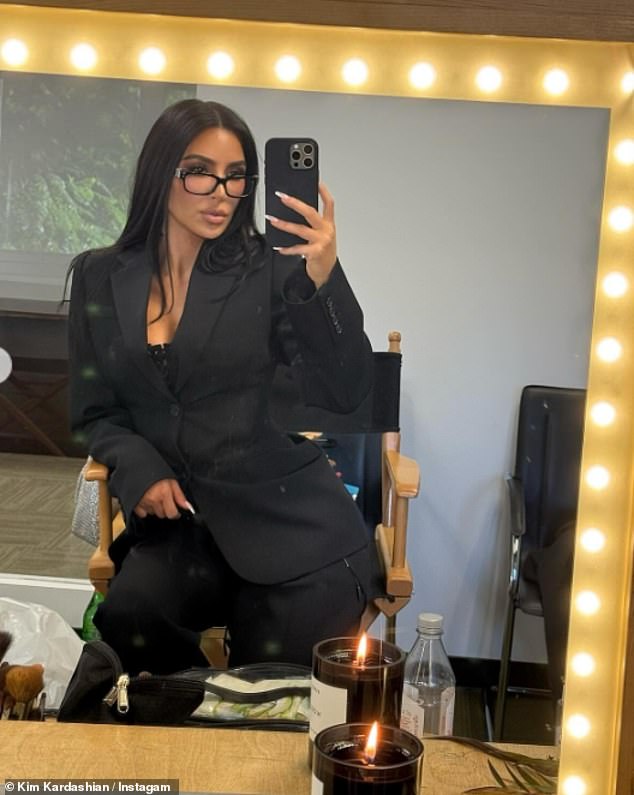 Sporting a more sophisticated look, the TV personality stunned in a sleek black jacket, matching pants and a pair of reading glasses as she posed for a mirror selfie.