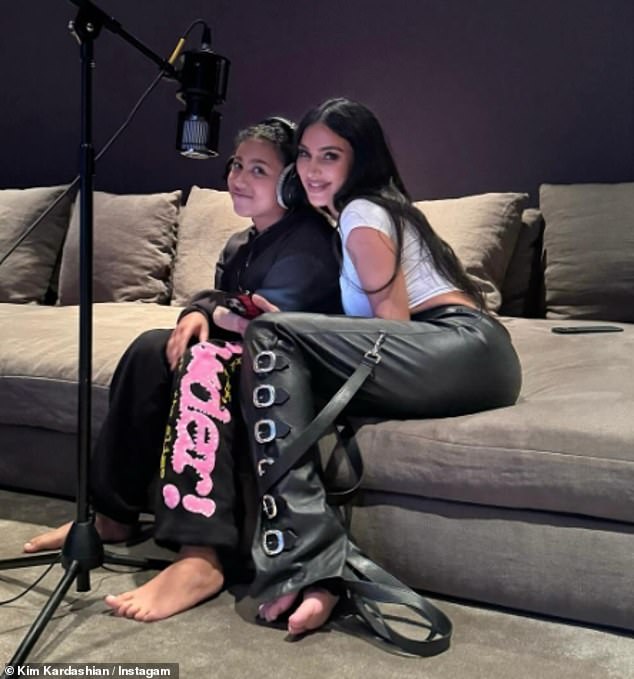 Kim couldn't contain her smile as she hugged her eldest daughter, North, while recording voiceovers while sitting on a huge couch.