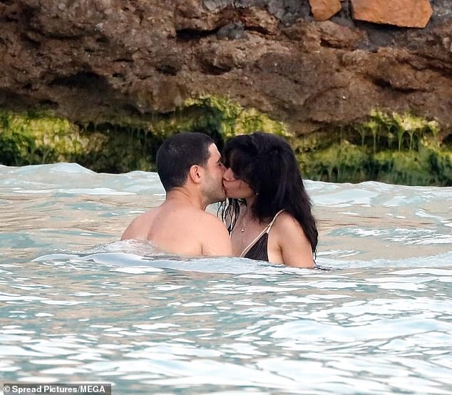 The singer, 27, was spotted sharing a passionate kiss with Henry Junior Chalhoub, 38, as they enjoyed a dip in Caribbean waters during their romantic getaway on Saturday