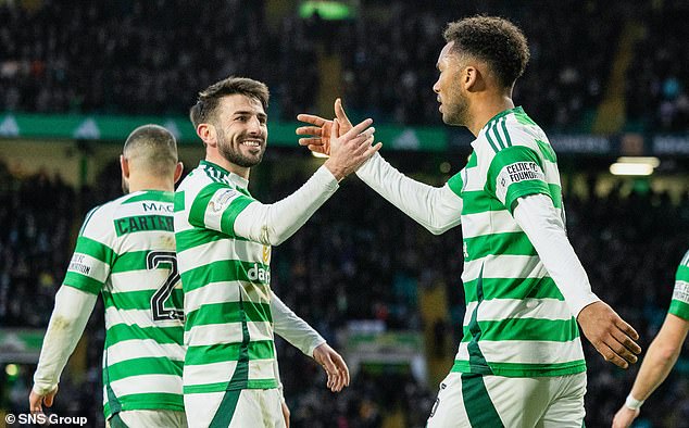 Taylor, left, greets Trusty after the centre-back scored his first goal for Celtic.