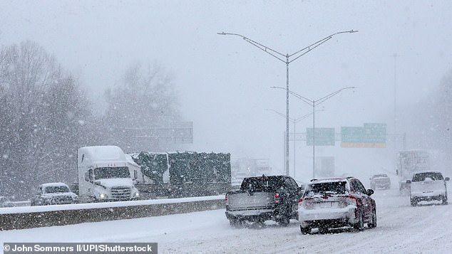 Trucks and cars are stranded in heavy snow on Interstate 264 in Louisville, Kentucky on Sunday