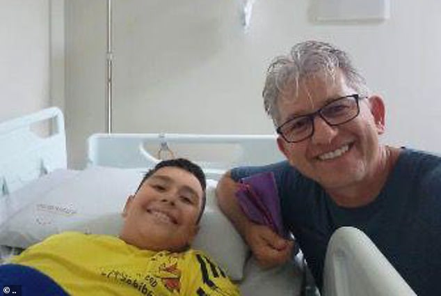 Matheus Marques da Silva, 10, survived by eating the poisoned cake with Father Leonir Alves in the hospital in Torres, Brazil.