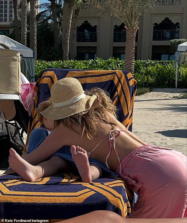 The WAG was seen cuddling her two children - son Cree, four, and daughter Shae, 18 months - as they relaxed on the same sun lounger on the beach.