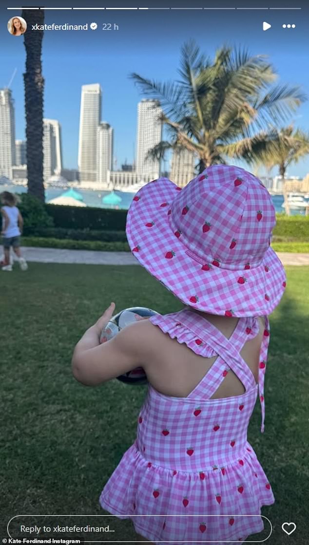 Also enjoying a sun-soaked day, Shae looked adorable in a pink and white strawberry print swimsuit and matching hat while holding a mini soccer ball.