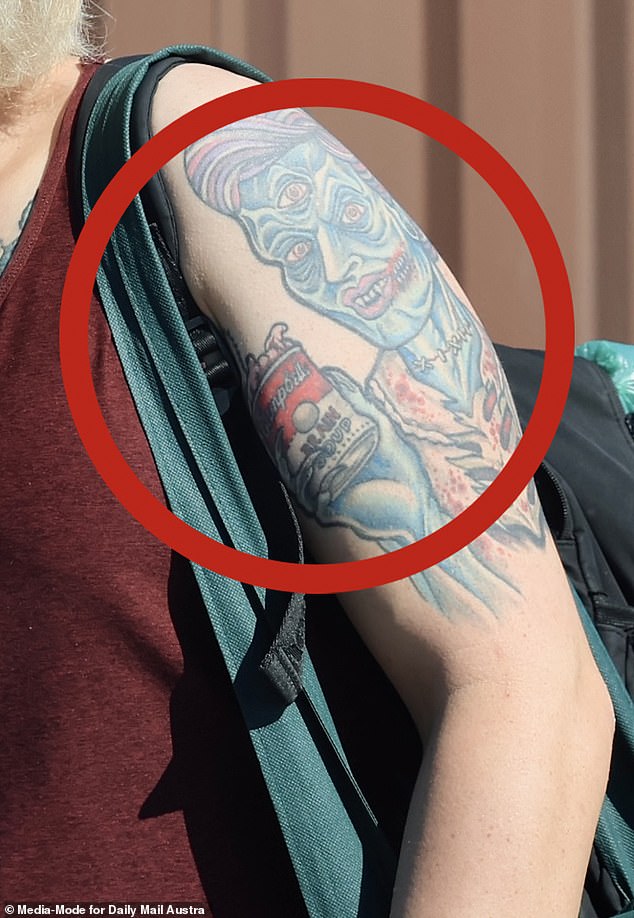 Wearing jeans, Vans skater shoes and a maroon sleeveless top, the tattoos visible on Amati's arm depicted a skeleton dressed in a suit and a zombie eating a can of 'BRAIN SOUP'.