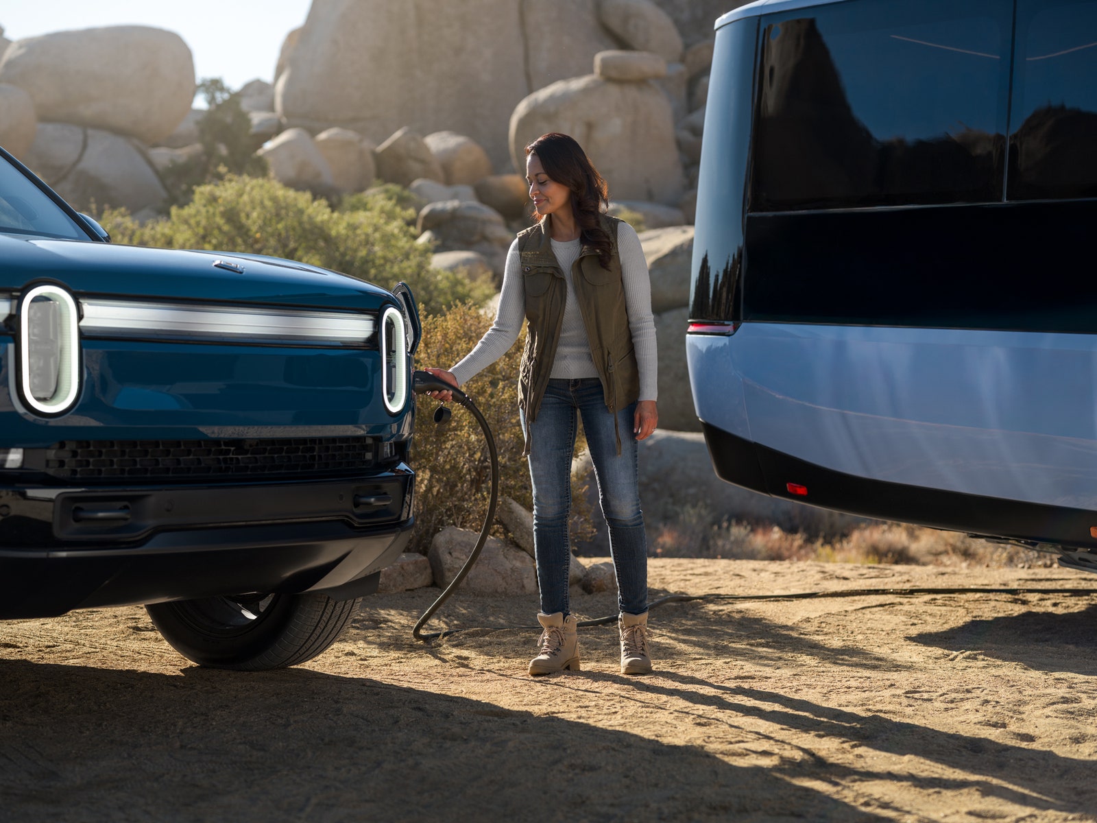 A press image of Pebble's new electric RV acting as a charging center for other electric vehicles.