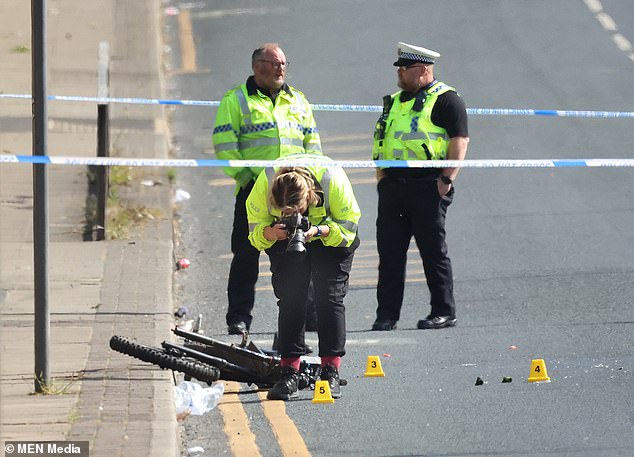 Officers at the scene of the accident on Langworthy Road, Salford, on the afternoon of June 8.