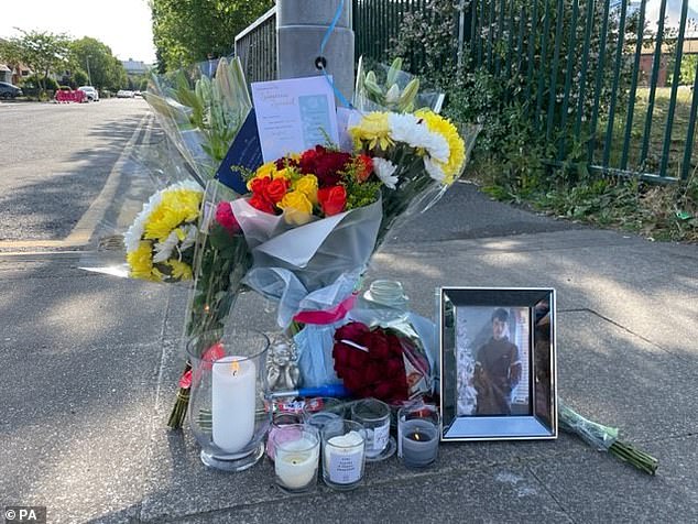 Floral tributes were tied to lampposts and candles were lit in memory of the teenager