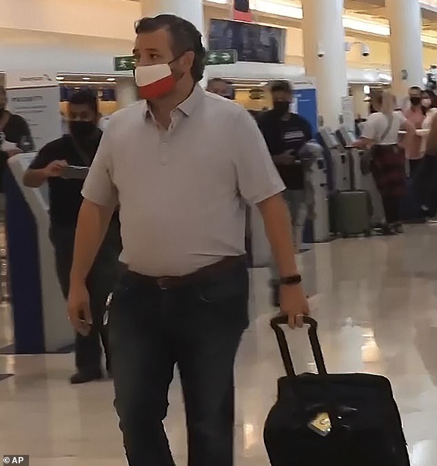 In this image from the video, Sen. Ted Cruz, R-Texas, walks to check in for his flight back to the U.S. at Cancun International Airport in Cancun, Mexico, Thursday, Feb. 18, 2021