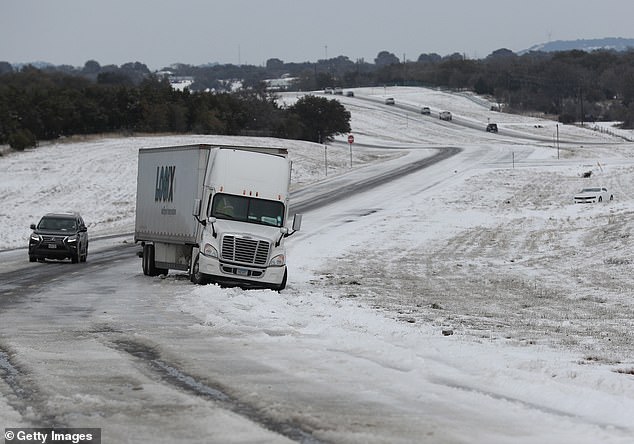 A tractor trailer is stuck in slick ice and snow on State Highway 195 on February 18, 2021 in Killeen, Texas. Winter Storm Uri brought historic cold weather and power outages to Texas as storms swept across 26 states with a mix of freezing temperatures and precipitation