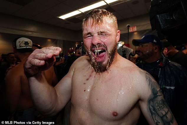 Lux celebrates with his teammates in the clubhouse after beating the Yankees in October