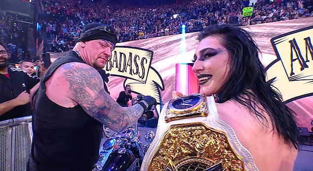 The Undertaker, as the American Badass, and Rhea Ripley share a cool moment