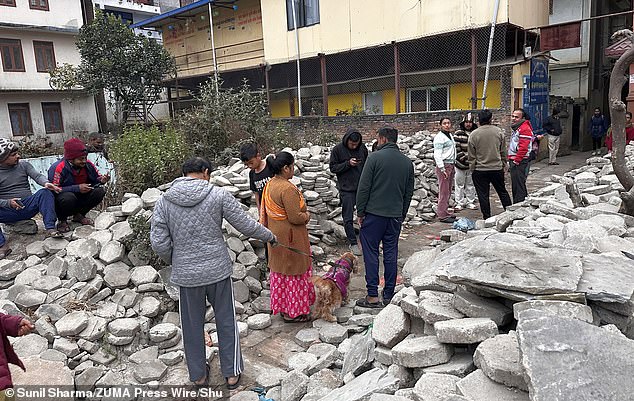 Villagers gathered to assess damage after the earthquake shook Nepal and Tibet