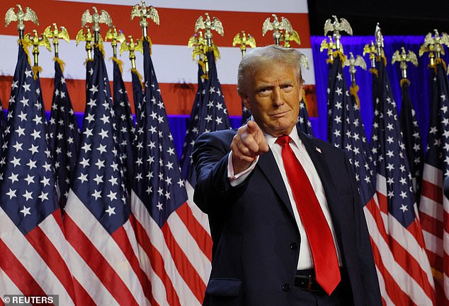 Donald Trump points to the camera at his election night victory party