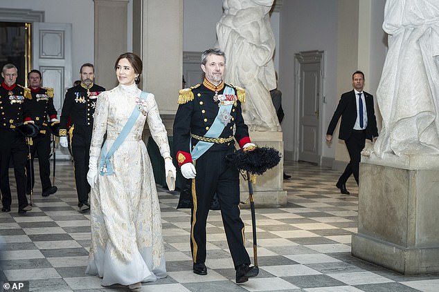 The mother of two looked angelic in a long gold brocade dress with wide sleeves and a high neck.