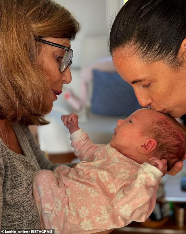 He confirmed that Georgie and her husband Alex Merkel welcomed a daughter named Heidi and shared a photo of his wife Libby meeting the little one (pictured).