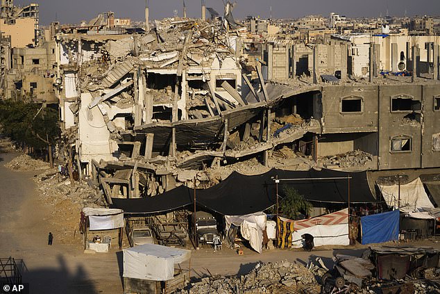 Palestinians walk among the destruction in Khan Younis, southern Gaza Strip, on January 7, 2025.