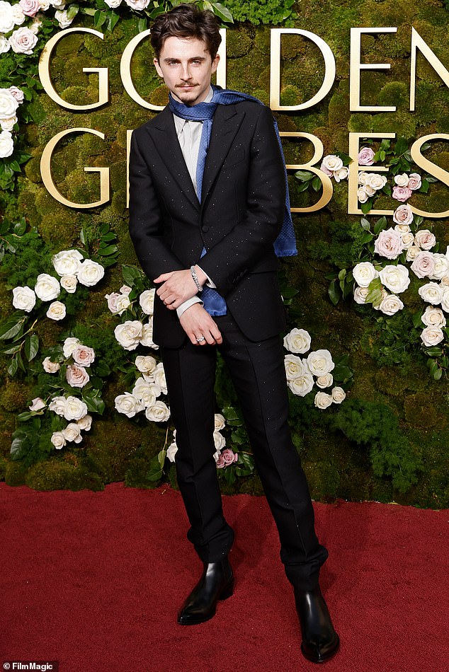 Timothee stepped onto the carpet alone, wearing a scarf instead of a tie in an homage to the boho chic that became an indelible part of Bob Dylan's image.