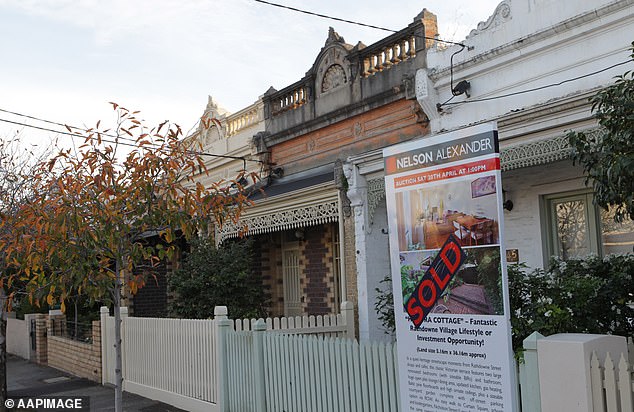 Australia's two largest cities are showing signs of a housing crisis. A sold sign is seen in front of a house in Brunswick, Melbourne.