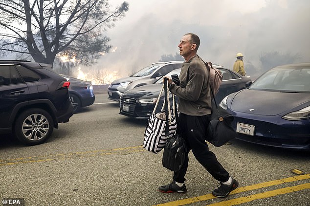 A man is seen abandoning his car in a traffic jam as he tries to evacuate